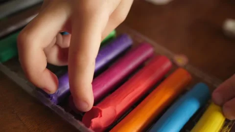 Child hand taking piece roll of pink plasticine school Stock-Footage 139389032
