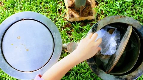 Child hand throwing plastic recycling container garbage Stock Footage 218213569