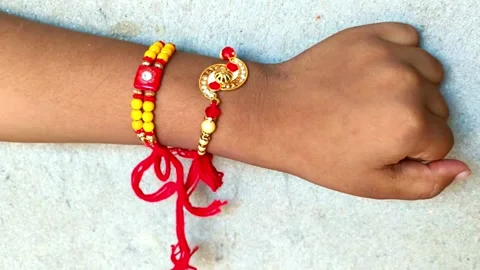 Child Hand Tied with Two Decorative Rakhis for Raksha Bandhan Festival Stock Footage 341865124
