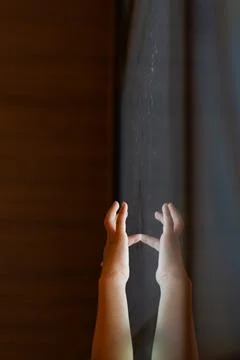 Child hand touching an illuminated interactive surface with reflection repr.. 库存照片