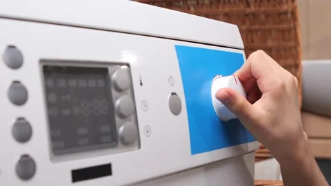 Child hand turning washing machine dial on control panel, selecting program and 스톡 동영상 324762837