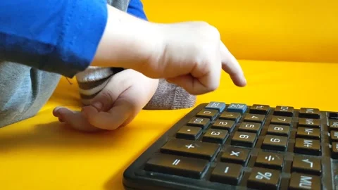 Child hands with calculator counting during school homework. Kid fingers press Stock Footage 270747712