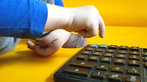 Child hands with calculator counting during school homework. Kid fingers press Stock Footage 287298749