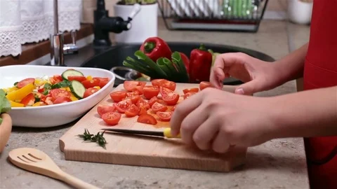 Child hands chopping up cherry tomatoes Stock Footage 77716383
