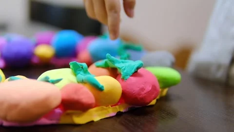 Child hands creating Easter eggs from play dough Stock-Footage 285268725