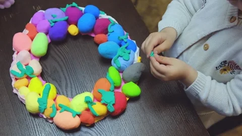Child hands creating Easter eggs from play dough Stock-Footage 285268741