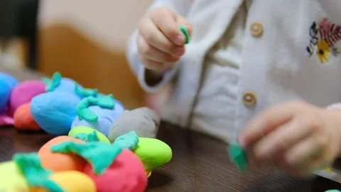 Child hands creating Easter eggs from play dough Stock-Footage 285268757