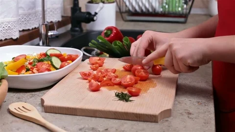 Child hands cutting cherry tomato - side view Stock Footage 80114912