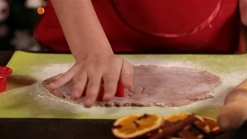 Child hands cutting the gingerbread cookie dough Video stock 80214101
