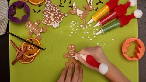 Child hands decorate gingerbread man Stock Footage 80328125