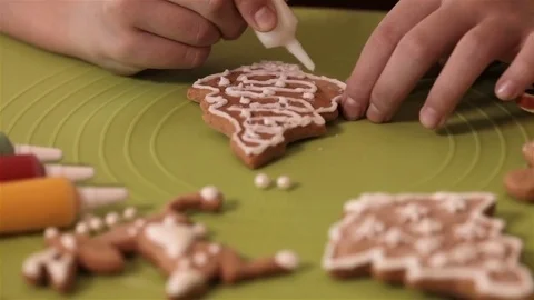 Child hands decorating christmas gingerbread cookie Stock Footage 80299090