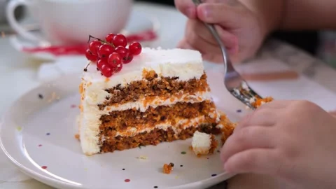 Child Hands Eating Slice of Carrot Cake with Red Currants Using Fork Stock Footage 342602612