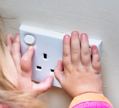 Child Hands on electrical sockets Stock Photos