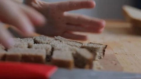 Child hands with knife cutting bread on board Stock Footage 102544439
