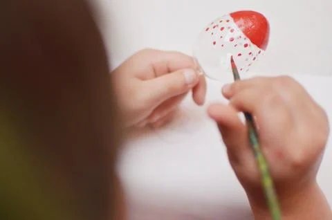 Child hands painting easter egg with red ponits Stock Photos