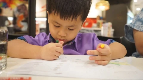 Child hands paints a colored pencils on a paper 스톡 동영상 74607053