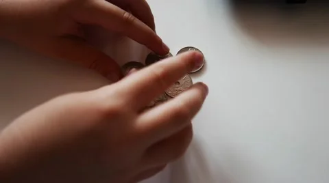 The child Hands play with coins. Stock Footage 62551700