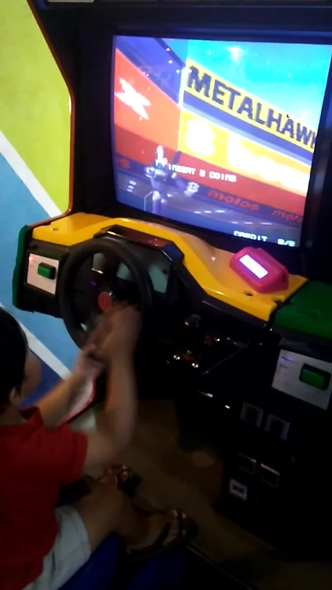 Child Hands Playing Classic Arcade Driving Game on Machine Screen Close Up Stock Footage 312267299
