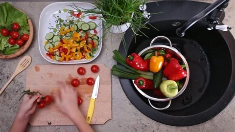 Child hands preparing tomatoes for salad - top view Stock Footage 80114778