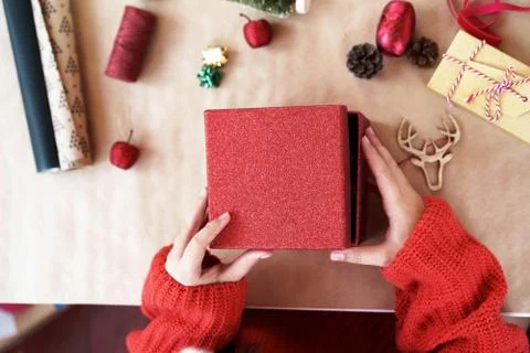 A child hands in red pullover opening red gift box closing. Stock Photos