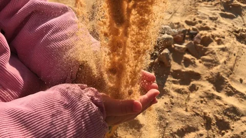 Child hands in sand at beach, time running concept, closeup Stock Footage 129338136