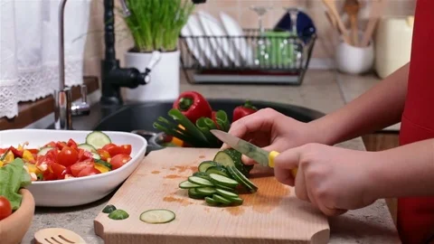Child hands slicing a cucumber - side view Stock Footage 80114938
