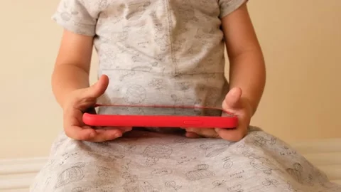 Child hands with smartphone close up 動画素材 135577028