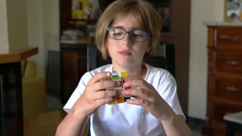 Child hands trying to solve Rubik's cube Stock Footage 136285015