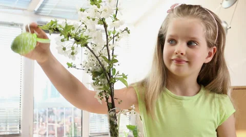 Child hang easter egg on cherry branch. Stock Footage 36838911