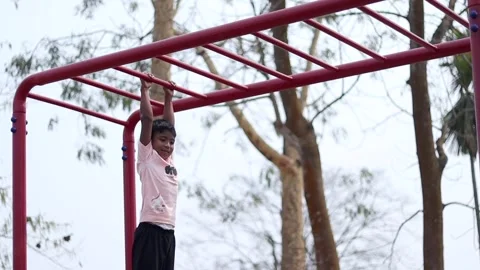 Child Hanging on Monkey Bars at Outdoor Playground in Dibrugarh 스톡 동영상 334774428