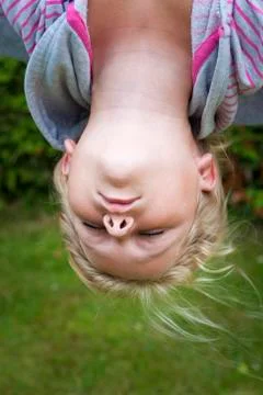 Child hanging upside down Stock Photos