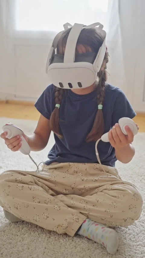 A Child Happily Engaging in an Exciting Virtual Reality Experience While Using Stock Footage 314619027