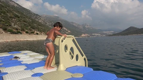 Child has fun on pontoon against beautiful view on Kas Stock Footage 120214575