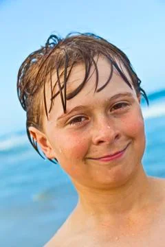 Child has fun in the waves of the ocean Stock Photos