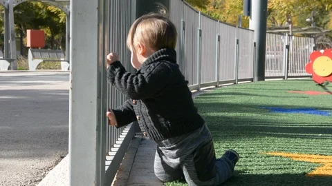 Child have fun on playground in park on sunny weekend day. Little Boy In A Playg Vidéo 102203124