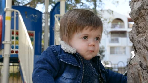 Child have fun on playground in park on sunny weekend day. Little Boy In A Playg Видео 104874929