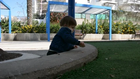 Child have fun on playground in park on sunny weekend day. Little Boy In A Playg Vídeo Stock 104875163
