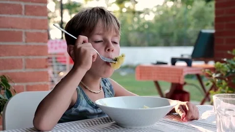 Child having dinner at the sunset   Stock-Footage 138437682