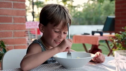 Child having dinner at the sunset   Stock Footage 138437685