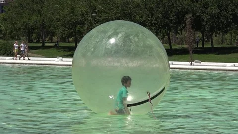 Child Having Fun In Big Plastic Ball In Pool in  Valencia city in  spain Stock Footage 99289251