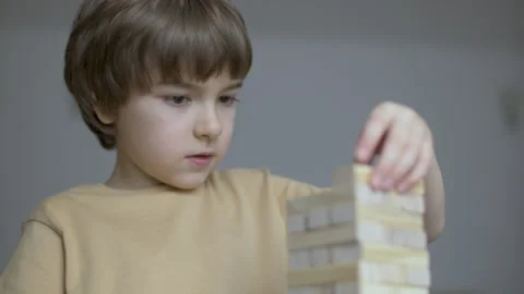 Child Having Fun Building Constructor Tower of Wooden Blocks. Boy Playing W.. Stock Footage 303372504