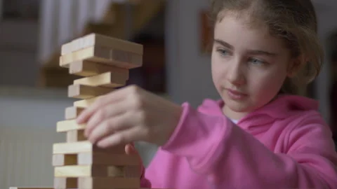 Child Having Fun Building Constructor Tower of Wooden Blocks. Girl Playing .. Stock Footage 303373414