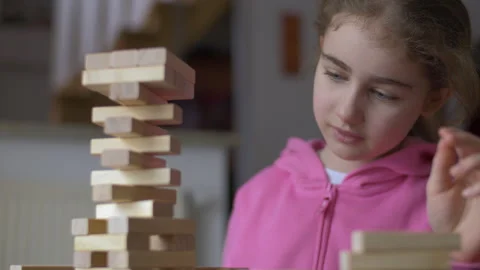 Child Having Fun Building Constructor Tower of Wooden Blocks. Girl Playing .. Stock Footage 312990521