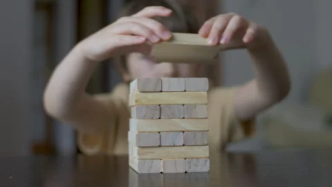 Child Having Fun Building Constructor Tower of Wooden Blocks. Boy Playing W.. Stock Footage 328751167