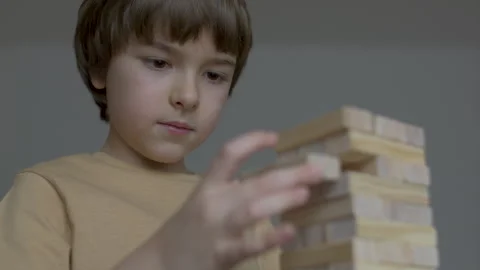 Child Having Fun Building Constructor Tower of Wooden Blocks. Boy Playing W.. Stock Footage 328761066