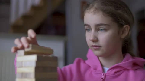 Child Having Fun Building Constructor Tower of Wooden Blocks. Girl Playing .. Video stock 328761076