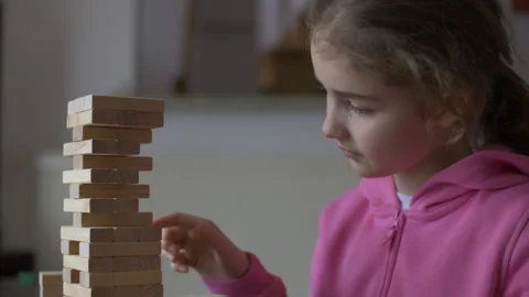 Child Having Fun Building Constructor Tower of Wooden Blocks. Girl Playing .. Stock Footage 328873519