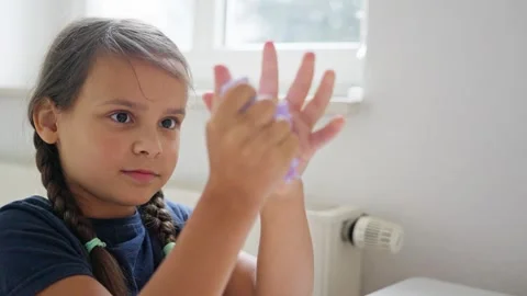 A Child Having Fun Creating and Playing with Homemade Purple Slime During Stock Footage 316819231