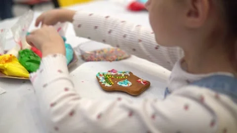 A Child Having Fun Decorating a Cookie with Colorful Icing Stock Footage 280410159