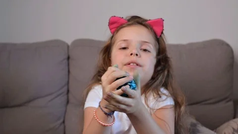 Child having fun making blue slime. Kid playing with hand made toy slime. Funny Video stock 126429581